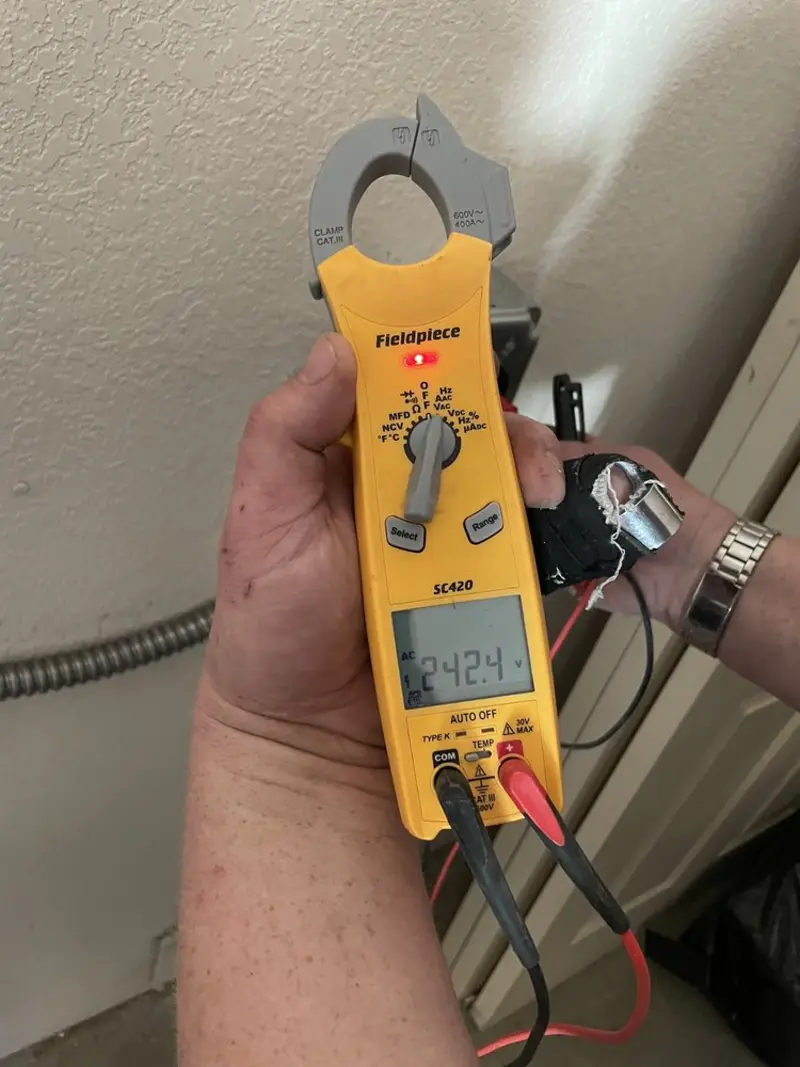 Voltage testing with clamp meter during Recessed Lighting Installation in Brock Hall